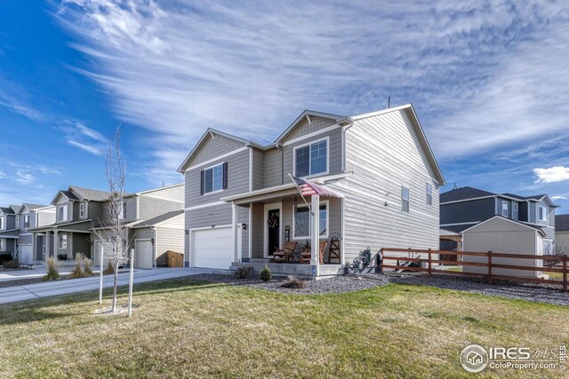 view of front facade featuring fence, a residential view, covered porch, concrete driveway, and an attached garage