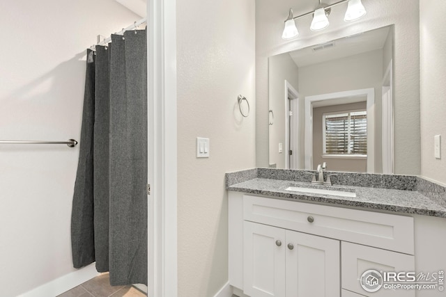 bathroom featuring tile patterned floors, visible vents, and vanity