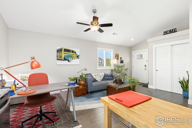 home office featuring vaulted ceiling, visible vents, a ceiling fan, and dark wood-style flooring