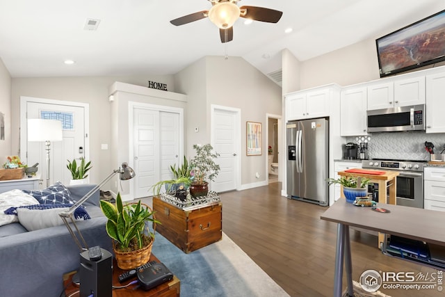 living room with dark wood-style floors, baseboards, recessed lighting, a ceiling fan, and high vaulted ceiling