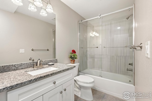 full bathroom with combined bath / shower with glass door, vanity, toilet, and tile patterned flooring