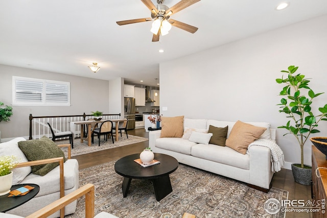 living area with dark wood finished floors, ceiling fan, and recessed lighting