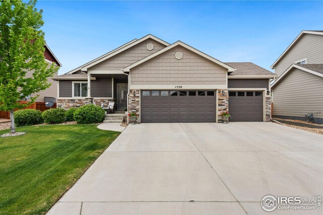 craftsman-style house with a front lawn and a garage