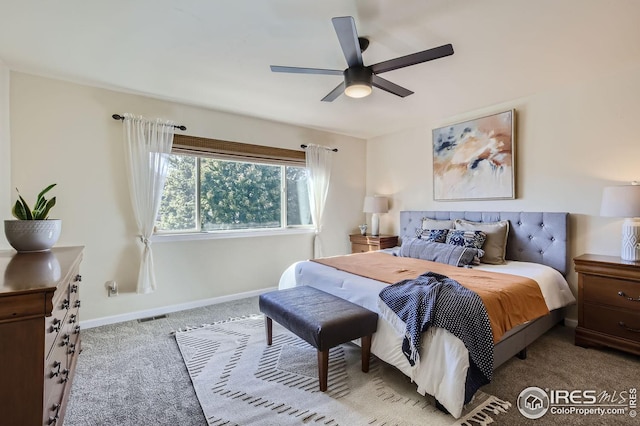 living area featuring light tile patterned floors, light colored carpet, ceiling fan with notable chandelier, baseboards, and stairway