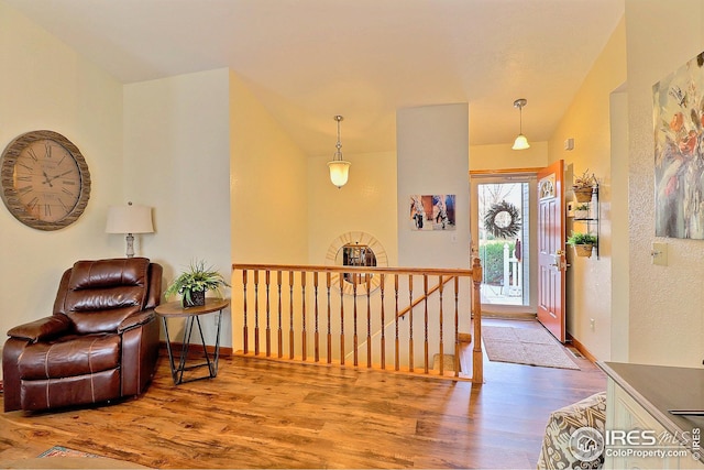 entrance foyer featuring hardwood / wood-style flooring and lofted ceiling