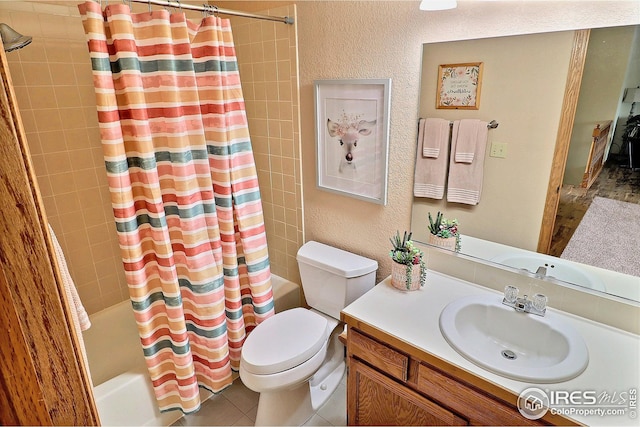 full bathroom featuring tile patterned floors, vanity, toilet, and shower / bath combo with shower curtain