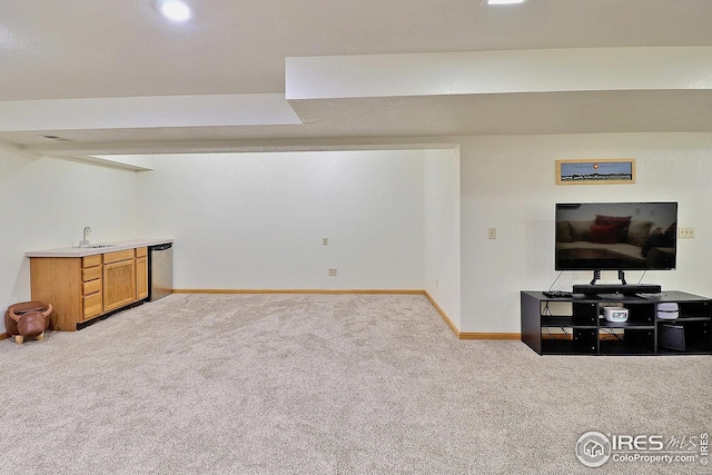 basement with sink and light colored carpet