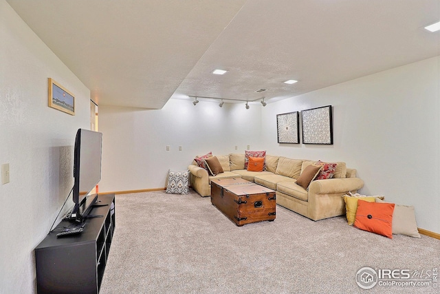 living room with light carpet, track lighting, and a textured ceiling