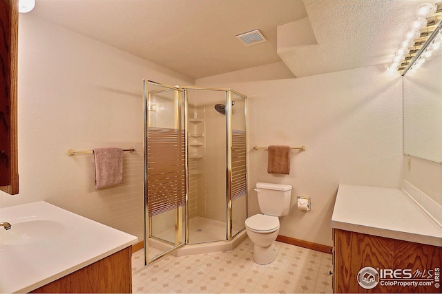 bathroom with walk in shower, vanity, and toilet