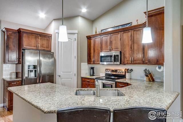 kitchen with kitchen peninsula, backsplash, stainless steel appliances, hanging light fixtures, and lofted ceiling