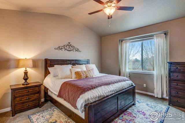 carpeted bedroom with ceiling fan and vaulted ceiling