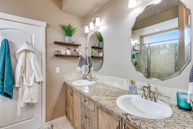 bathroom with vanity and a shower with shower door