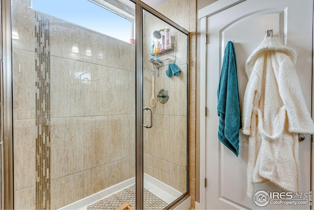 bathroom with a shower with door