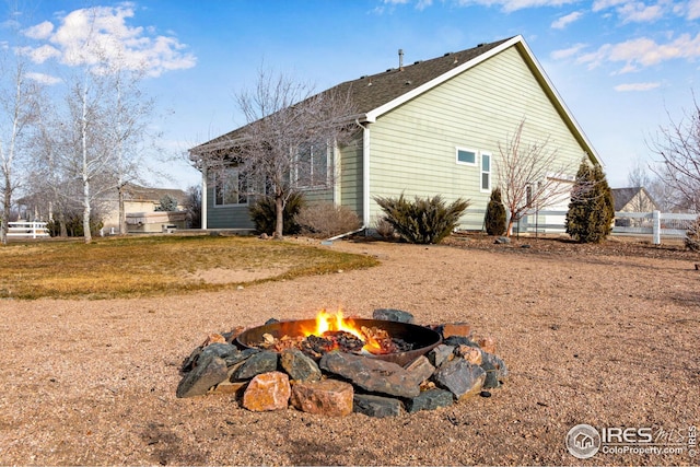 view of side of property with an outdoor fire pit