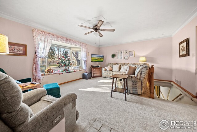 living room featuring light colored carpet, ceiling fan, and ornamental molding