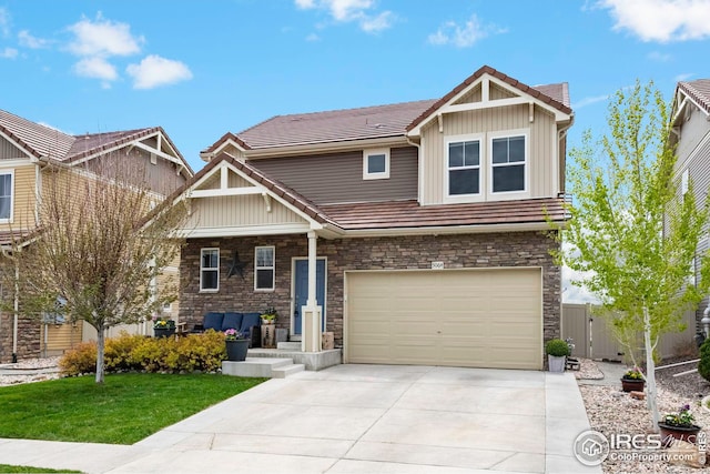 craftsman inspired home with a front yard and a garage