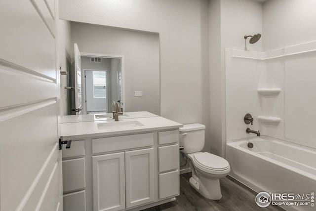 full bathroom featuring vanity, toilet, bathing tub / shower combination, and wood-type flooring