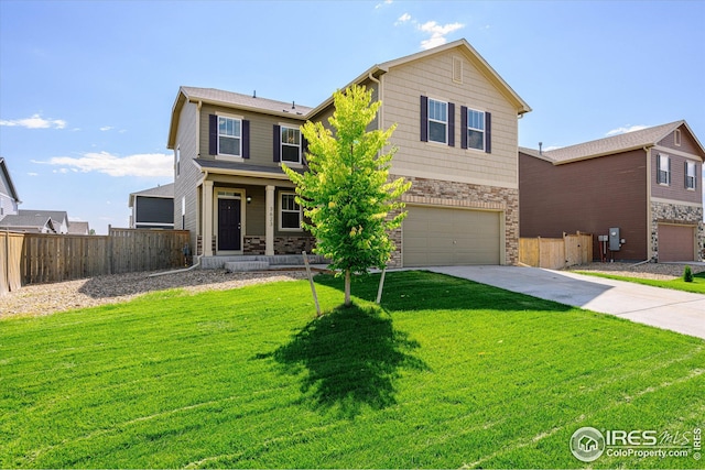 view of property featuring a garage and a front yard