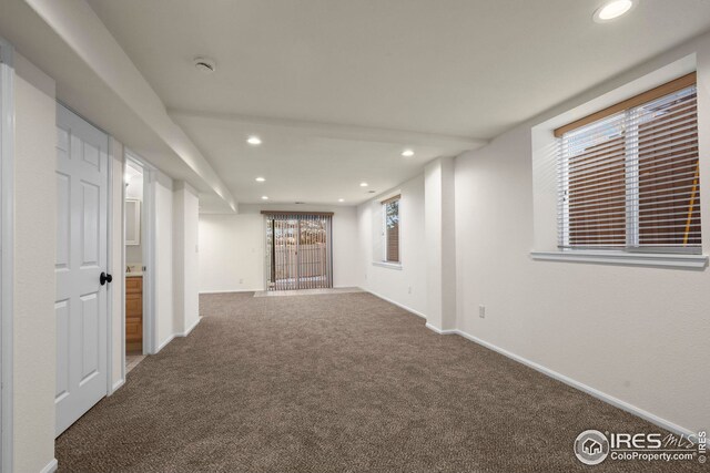 interior space with baseboards, carpet floors, and recessed lighting