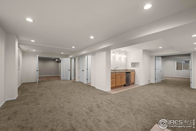 finished basement featuring light carpet, wet bar, and recessed lighting