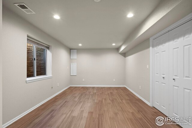 basement featuring wood finished floors, recessed lighting, baseboards, and visible vents