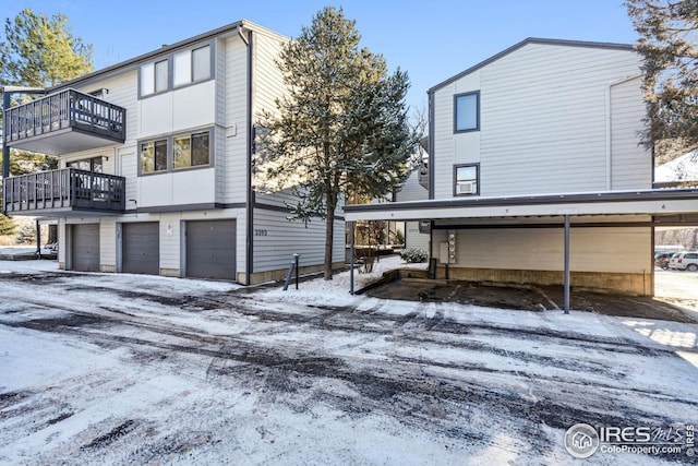 snow covered property with a balcony