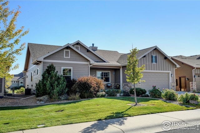 craftsman-style home with a garage and a front yard