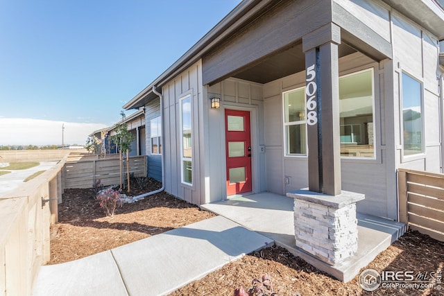 view of exterior entry featuring covered porch