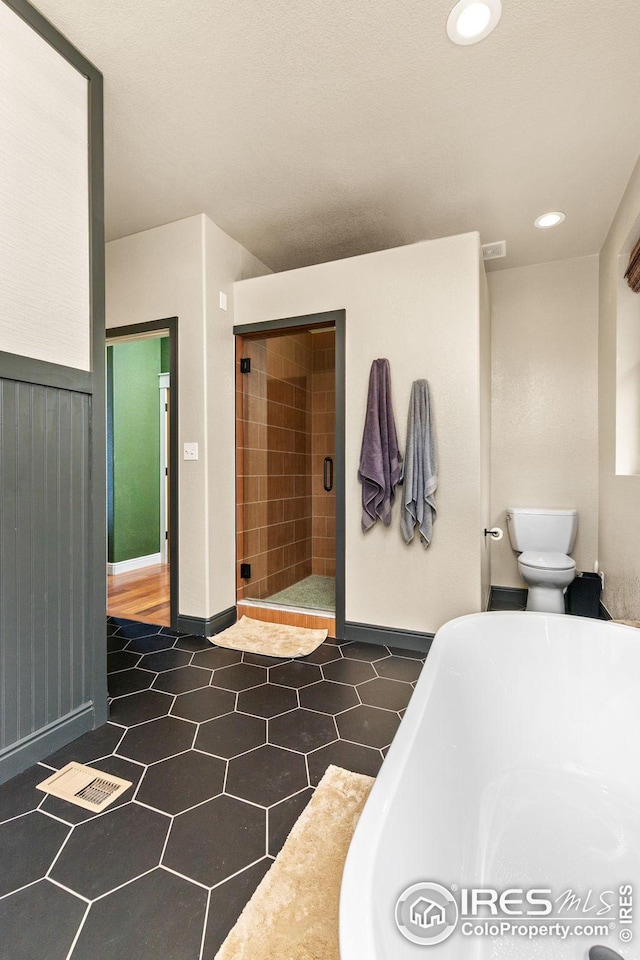 full bath with recessed lighting, a soaking tub, visible vents, toilet, and a stall shower