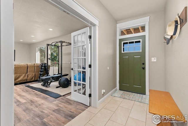 foyer with recessed lighting, wood finished floors, and baseboards