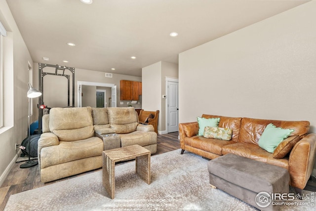 living area with recessed lighting, baseboards, and wood finished floors