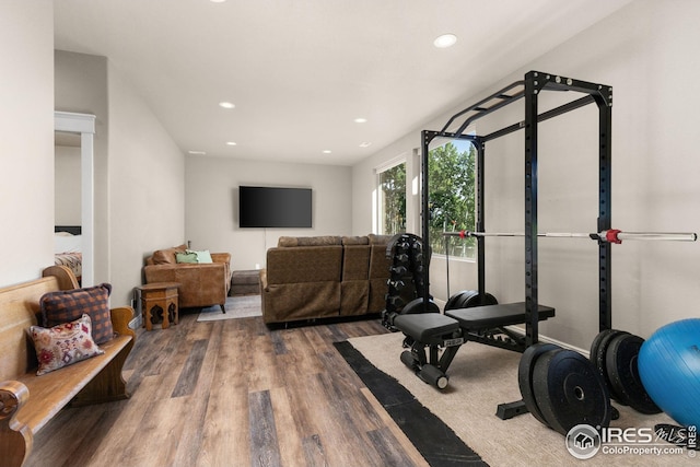 exercise room with wood finished floors and recessed lighting