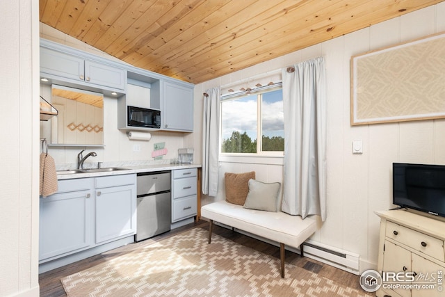 kitchen with black microwave, wooden ceiling, refrigerator, light countertops, and light wood finished floors