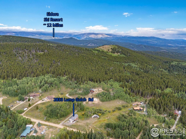 bird's eye view featuring a forest view and a mountain view