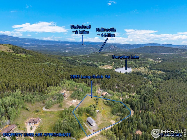 aerial view featuring a mountain view and a wooded view