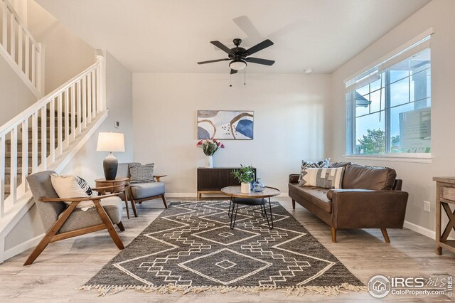 living room featuring ceiling fan and wood-type flooring