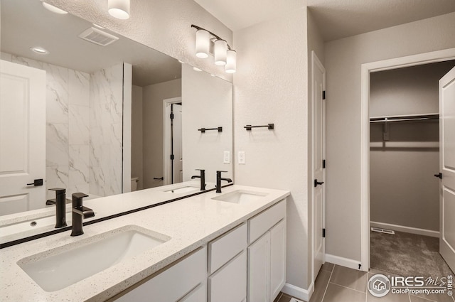 bathroom with tile patterned flooring and vanity