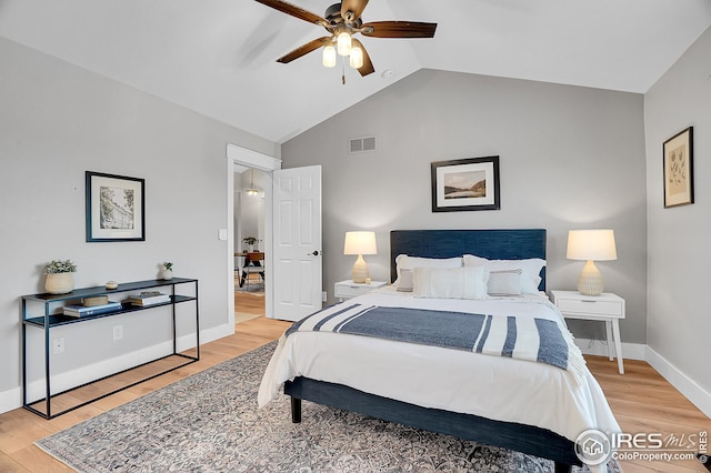 bedroom with hardwood / wood-style floors, vaulted ceiling, and ceiling fan