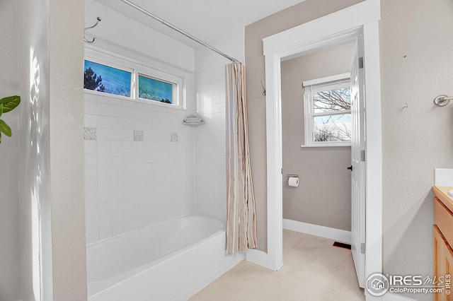 bathroom featuring shower / bath combo with shower curtain and vanity