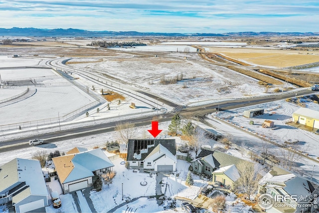 snowy aerial view featuring a mountain view