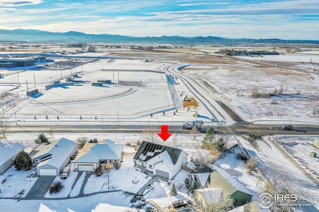 snowy aerial view featuring a mountain view