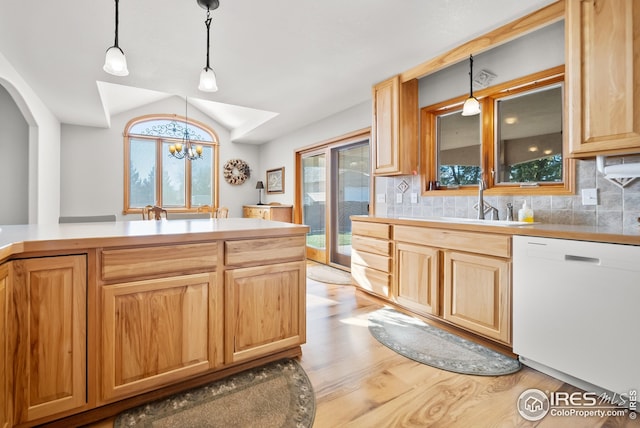 kitchen featuring hanging light fixtures, backsplash, a chandelier, and dishwasher