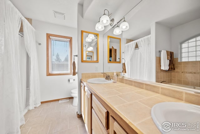 bathroom featuring tile patterned floors, vanity, and toilet