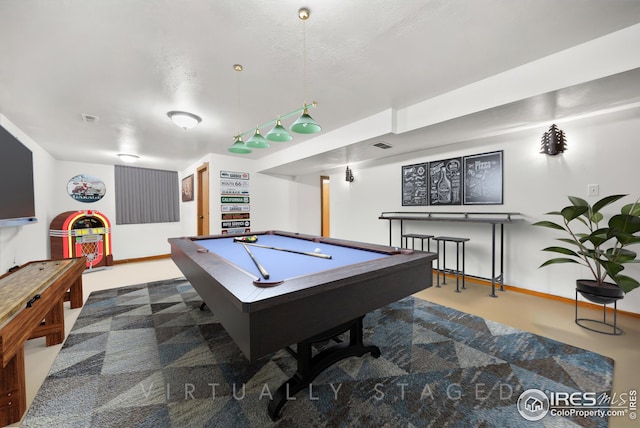 playroom with a textured ceiling and billiards