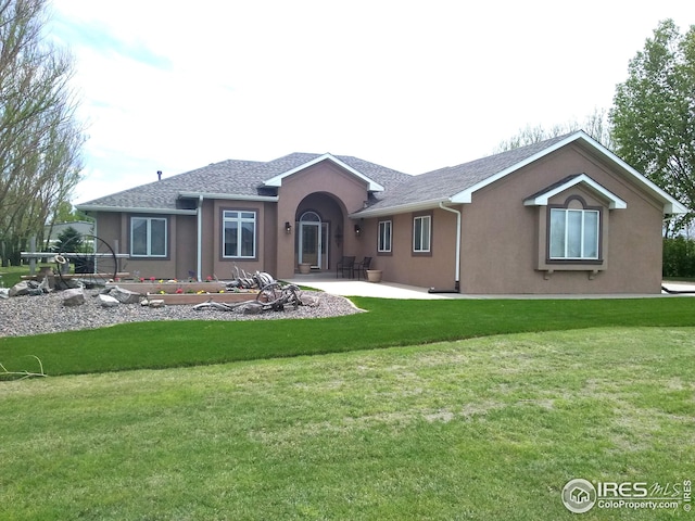 rear view of property with a patio area and a lawn