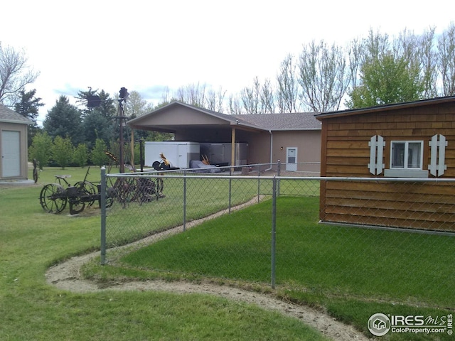 exterior space with a front yard and a carport