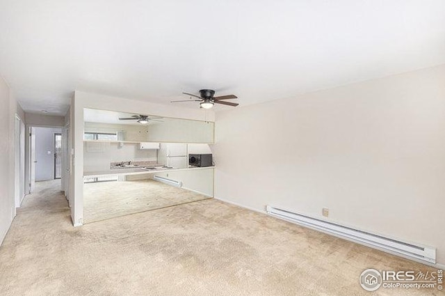 unfurnished living room with light carpet, baseboard heating, and ceiling fan