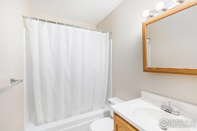 full bathroom with shower / bath combo, vanity, and toilet