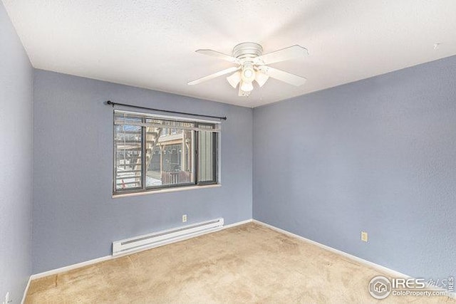 empty room featuring carpet floors, baseboard heating, and ceiling fan