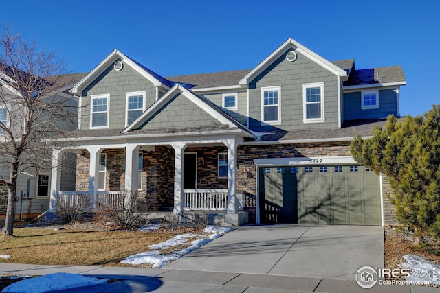 craftsman inspired home featuring covered porch and a garage